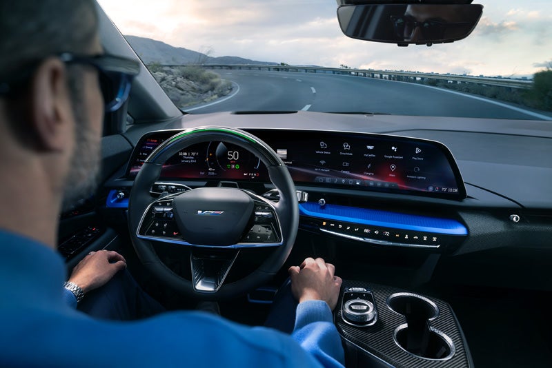 Front View of the 2026 OPTIQ-V Driving Through the Dusk Utilizing its Headlights | Bridgeton Cadillac in Bridgeton NJ